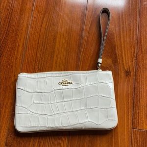 Coach cream colored wristlet, new. Never used.